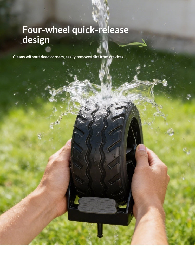 A person holds a black tire-shaped cleaning brush or roller outdoors over running water, with grass and a blurred outdoor background. White text at the top reads 'Four-wheel quick-release design' and 'Cleans without dead corners, easily removes dirt from crevices.