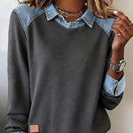 Gray sweatshirt with denim collar and cuffs worn by a person.