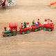 Wooden toy train set with Santa Claus figures on a wooden surface