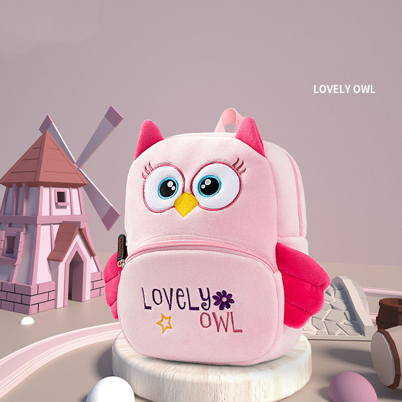 Pink owl-shaped backpack with 'Lovely Owl' text on a white background
