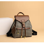 Backpack with houndstooth pattern and brown accents on a beige background