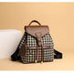 Backpack with houndstooth pattern and brown accents on a beige background