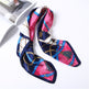 Colorful patterned scarf with a decorative buckle on a white background