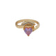 Gold ring with a heart-shaped pink gemstone on a white background
