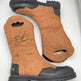 Pair of brown work boots with black soles on a white background