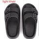 Pair of light khaki sandals with black straps on a white background