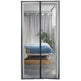 Magnetic screen door covering a bedroom with a bed and plant.