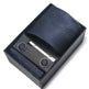 Navy patterned tie set with tie clip and cufflinks in a black box on a white background