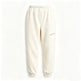 Cream-colored fleece jogger pants with an elastic waistband and cuffs, featuring a small diagonal zip pocket on the left thigh.