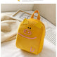 Yellow backpack with pig design on a light surface