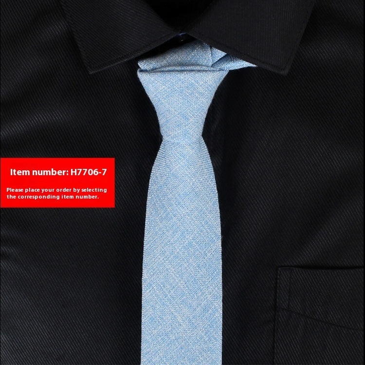 Light blue tie on a black shirt with a red item number label.