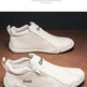 White sneakers with 'Daap' branding on a wooden surface