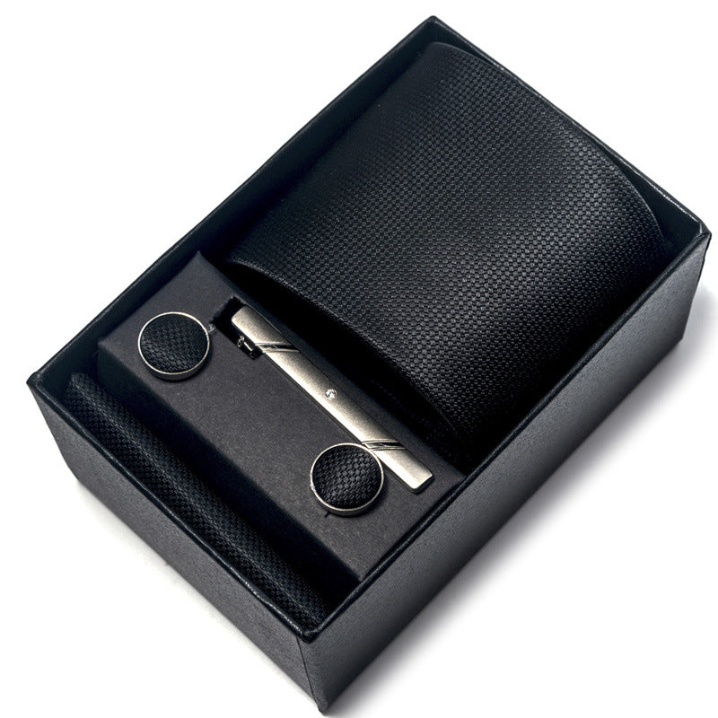 Black leather wallet with silver clip and cufflinks in a box on a white background