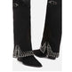 Black knee-high boots with studded details on a white background
