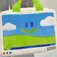 Laptop sleeve with smiley face design held by a person