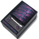 Floral tie set with tie, tie clip, and cufflinks in a black box on a white background