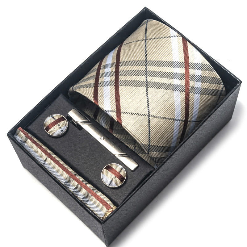 Tie, cufflinks, and tie clip set in a black box with plaid pattern.