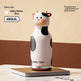 Cow-shaped thermos with 'Chicu Tom' branding on a beige background