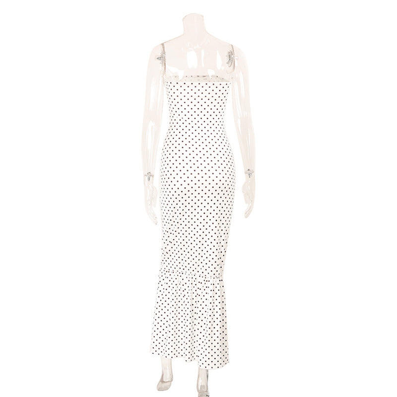 Mannequin wearing a polka dot dress on a white background