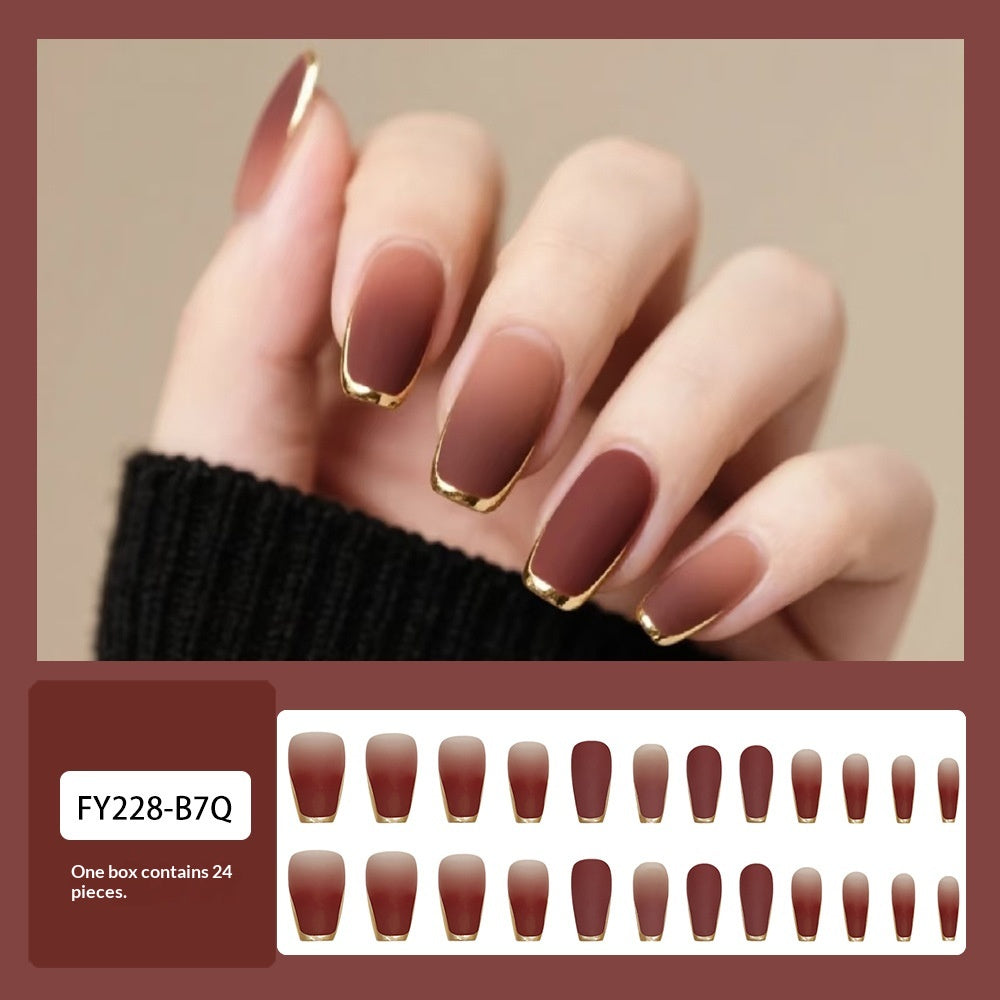 A hand wearing press-on nails with a gradient brown-to-rose finish and metallic gold tips, shown above a product swatch grid labeled FY228-B7Q and text stating one box contains 24 pieces.