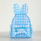 A light blue and white gingham check backpack shaped like a bunny, featuring upright ears and a front zippered pocket, shown against a plain light background.