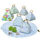 Set of triangular fabric covers with wooden handles on a matching round mat.