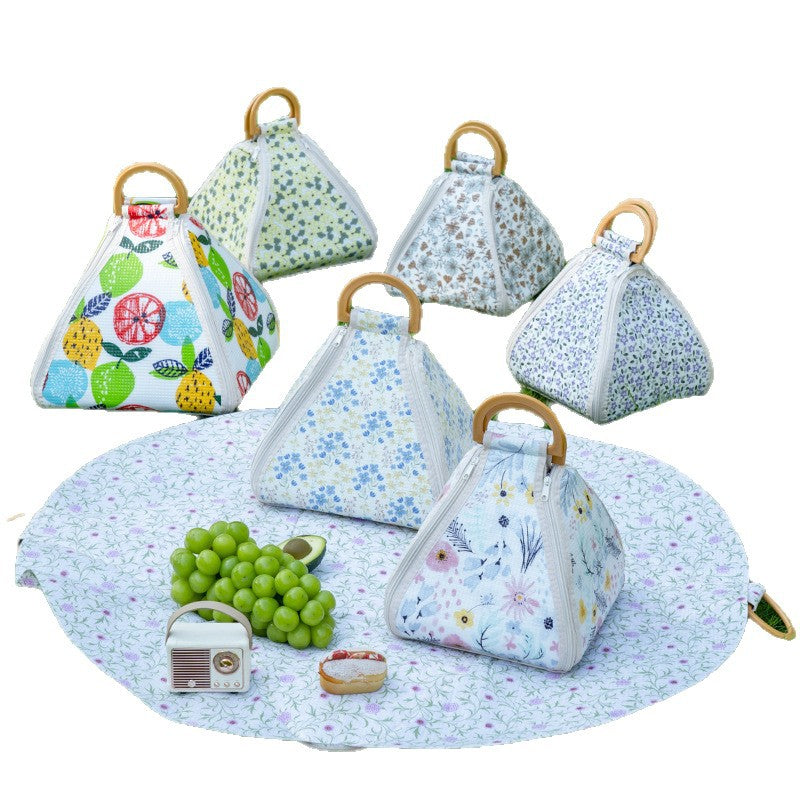 Set of triangular fabric covers with wooden handles on a matching round mat.