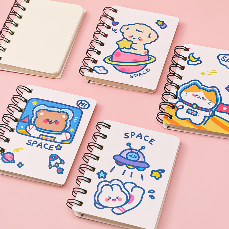 Set of small notebooks with space-themed illustrations on a pink background