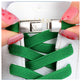 Green shoelaces being threaded through a white sneaker with a silver lace lock.
