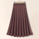 Brown skirt on a hanger against a beige background