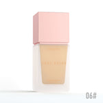 Foundation bottle with pink cap and beige shade on a white background
