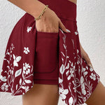 Maroon skirt with white floral pattern worn by a person against a white background