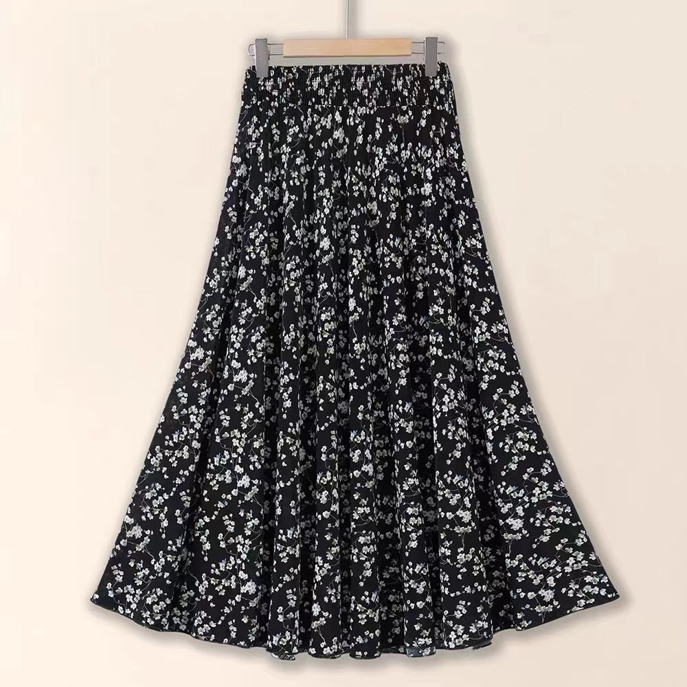 Black floral patterned skirt on a beige background