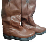 Pair of brown leather boots on a colorful surface with a blurred background