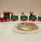 Toy train set with decorative elements on a white surface