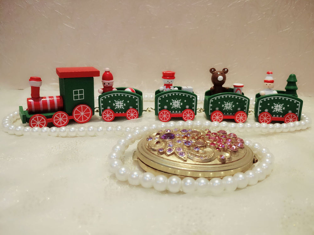 Toy train set with decorative elements on a white surface