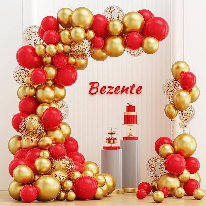 Balloon arch with red and gold balloons and a cake on a stand.
