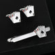 Cufflinks and tie clip set with playing card design on a black background