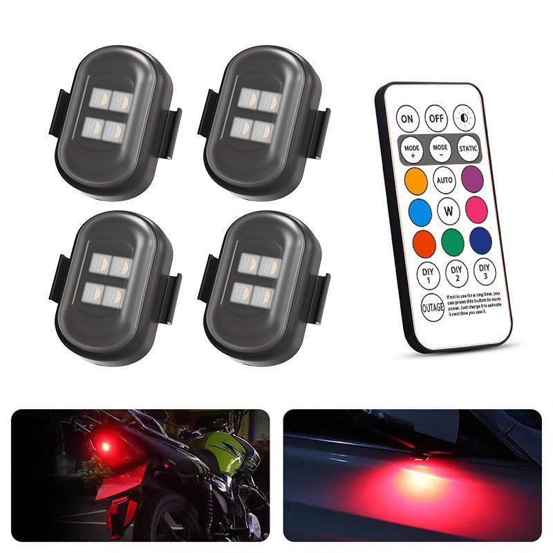 Four LED lights with a remote control on a white background