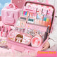 Pink stationery set with various items including a digital clock, notebooks, and stationery items, displayed in an open pink case.