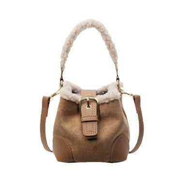 Brown handbag with fur trim on a white background