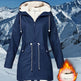 Navy blue winter jacket with fur-lined hood on a snowy mountain background