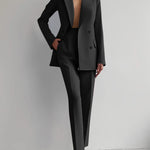 Person wearing a black suit with a white background