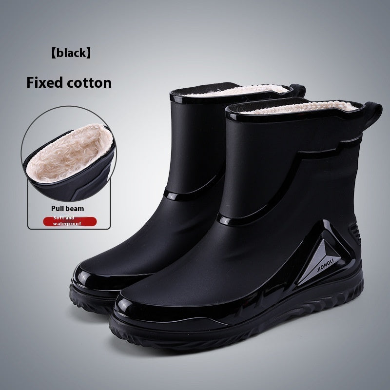 Black rain boots with white lining on a gray background