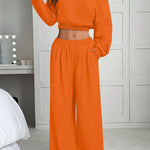 Person wearing an orange outfit in a bedroom setting