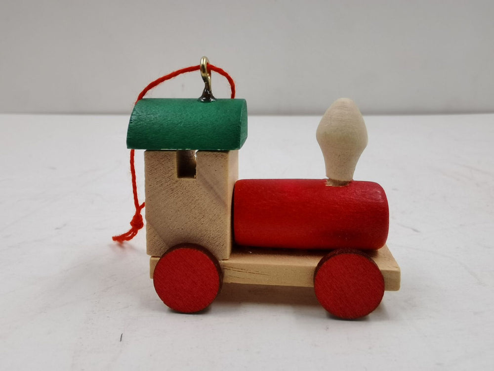 Wooden toy train with red and green colors on a white background