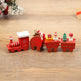 Wooden toy train set with Christmas-themed figures on a wooden surface