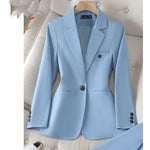 Light blue blazer on a hanger against a neutral background