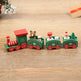 Wooden toy train set with Christmas-themed cars on a wooden surface