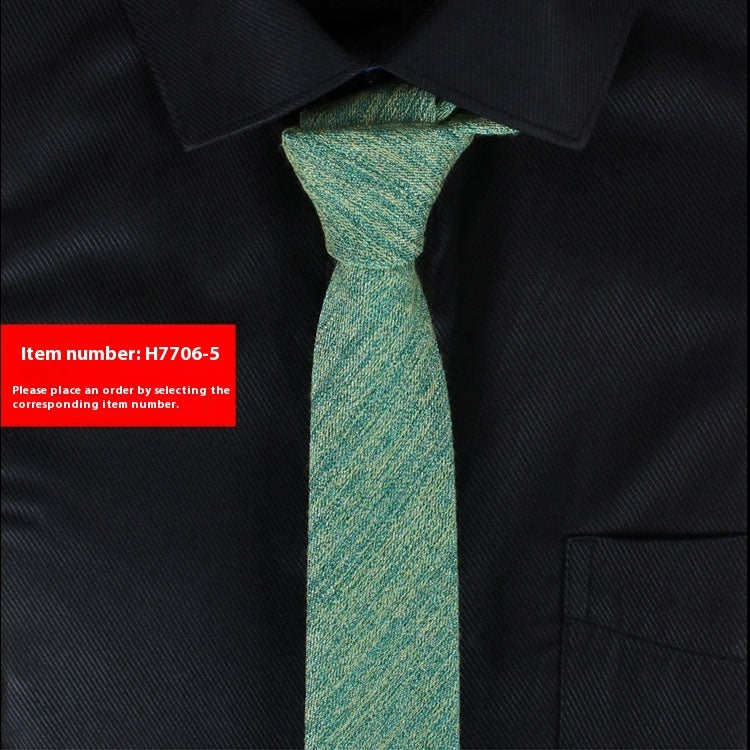 Green tie on a black suit with an item number label.